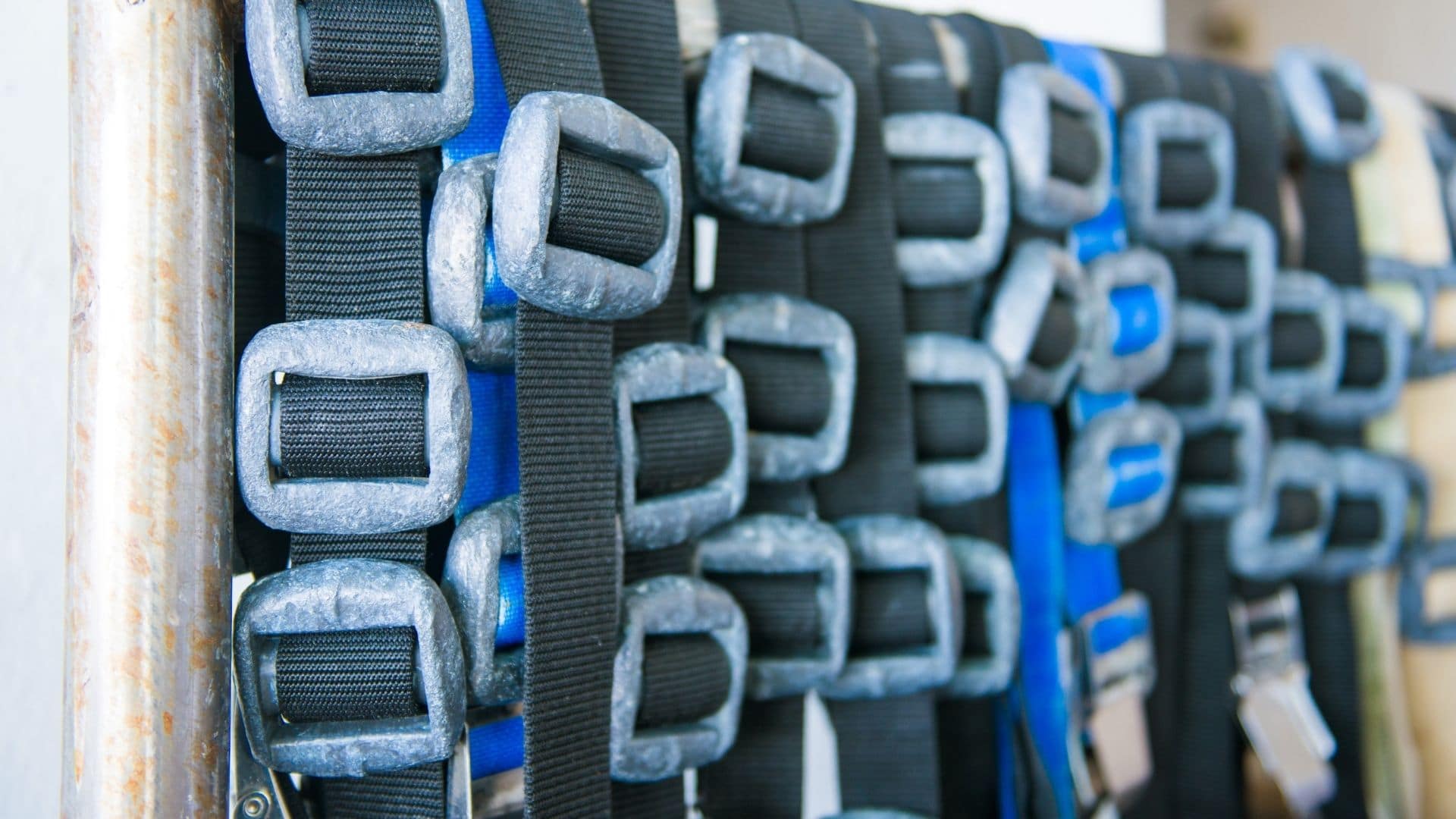image showing dive weights and dive weight belts drying on a rack